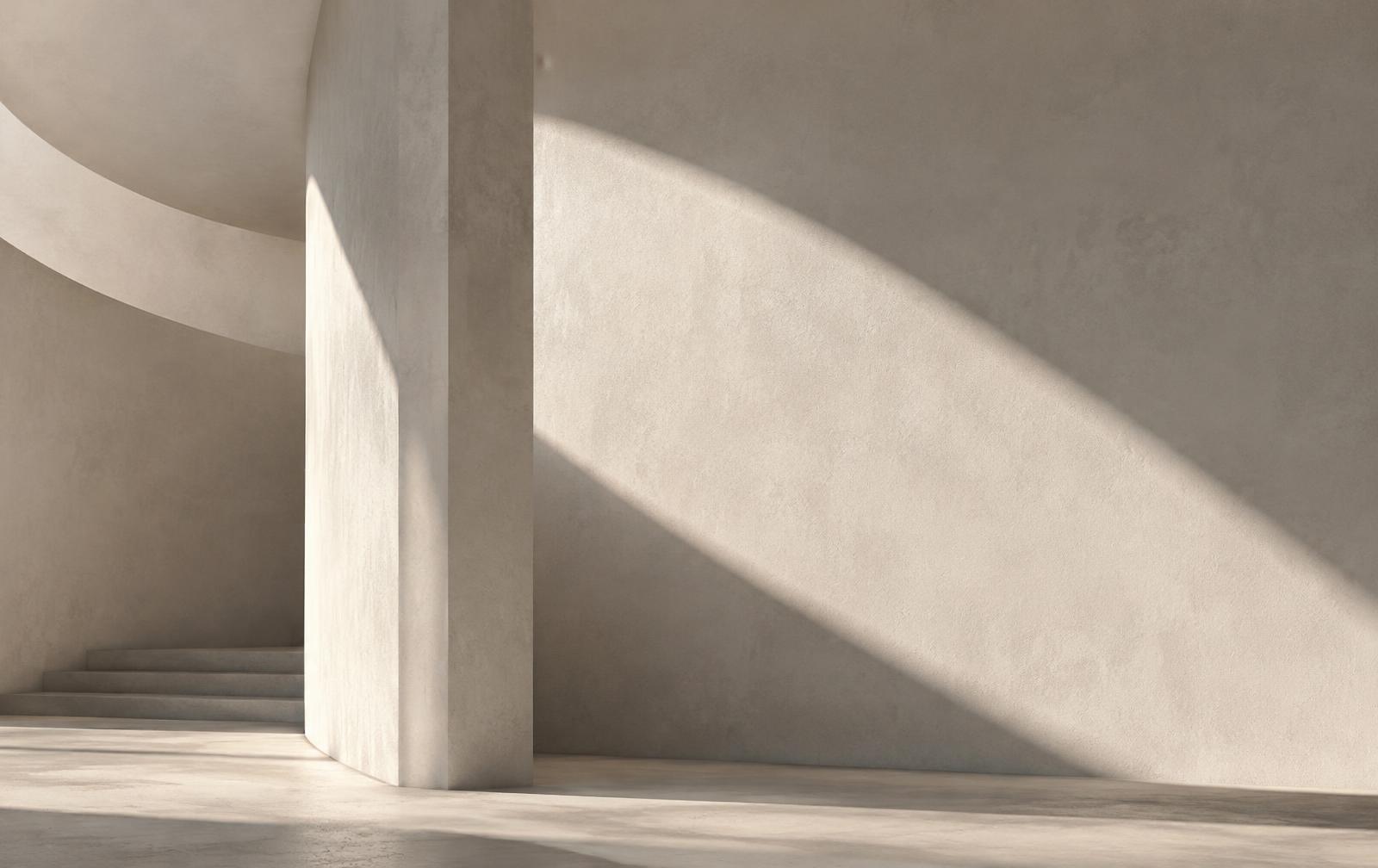 Soft light falling across curved plaster walls in a quiet architectural interior